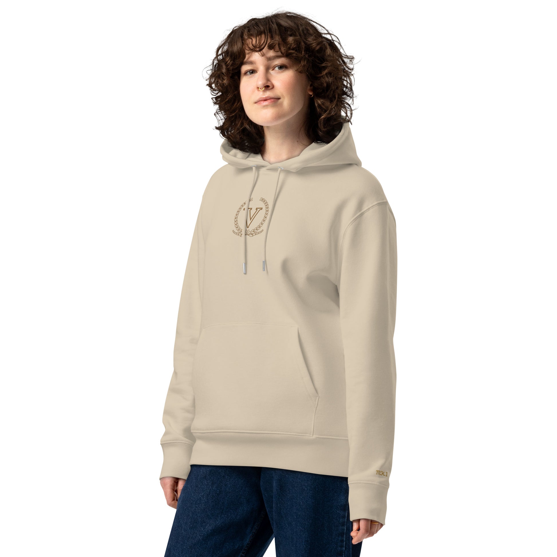 Person wearing a beige hoodie with a logo on a white background